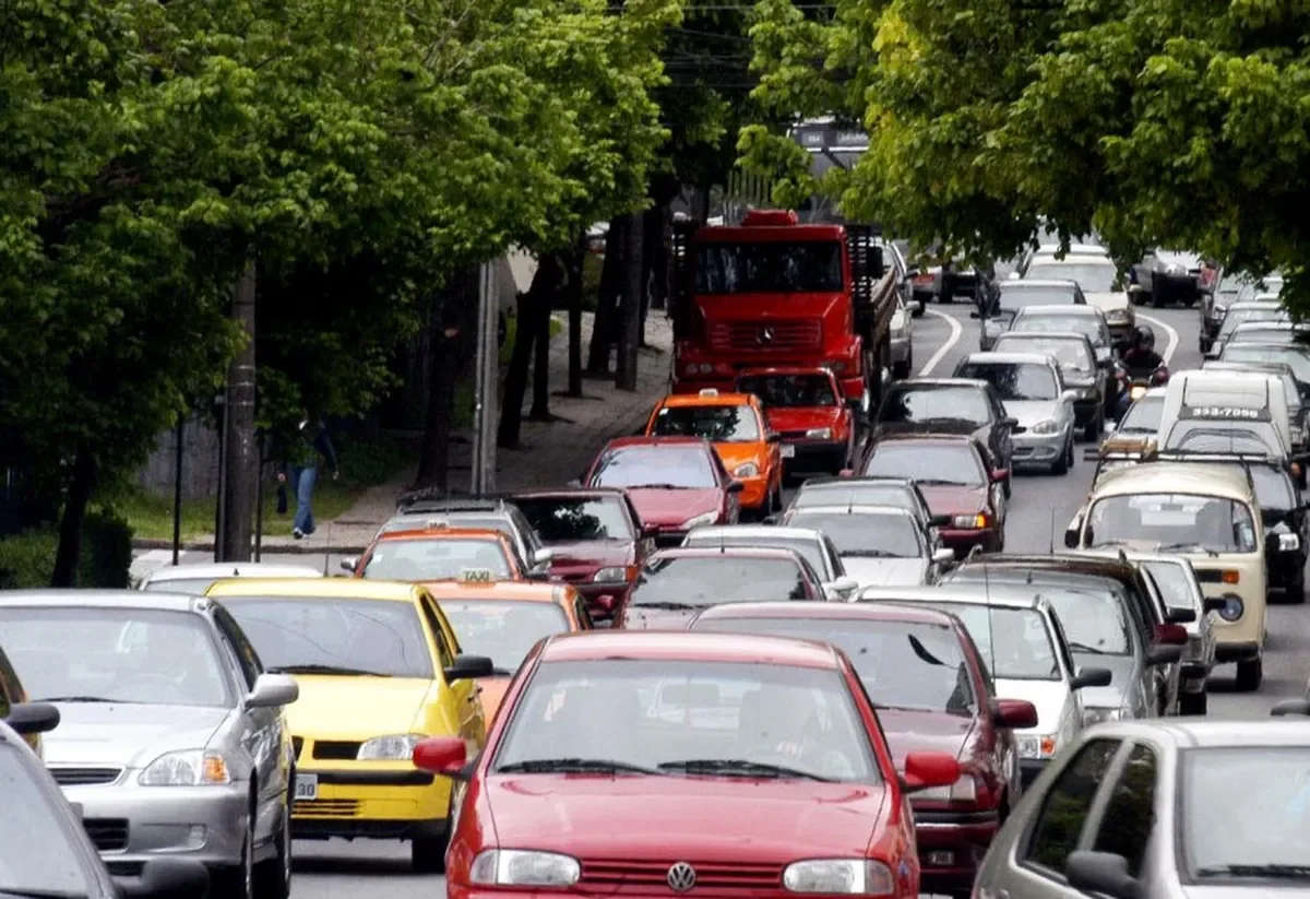 Vários carros em uma rua movimentada.