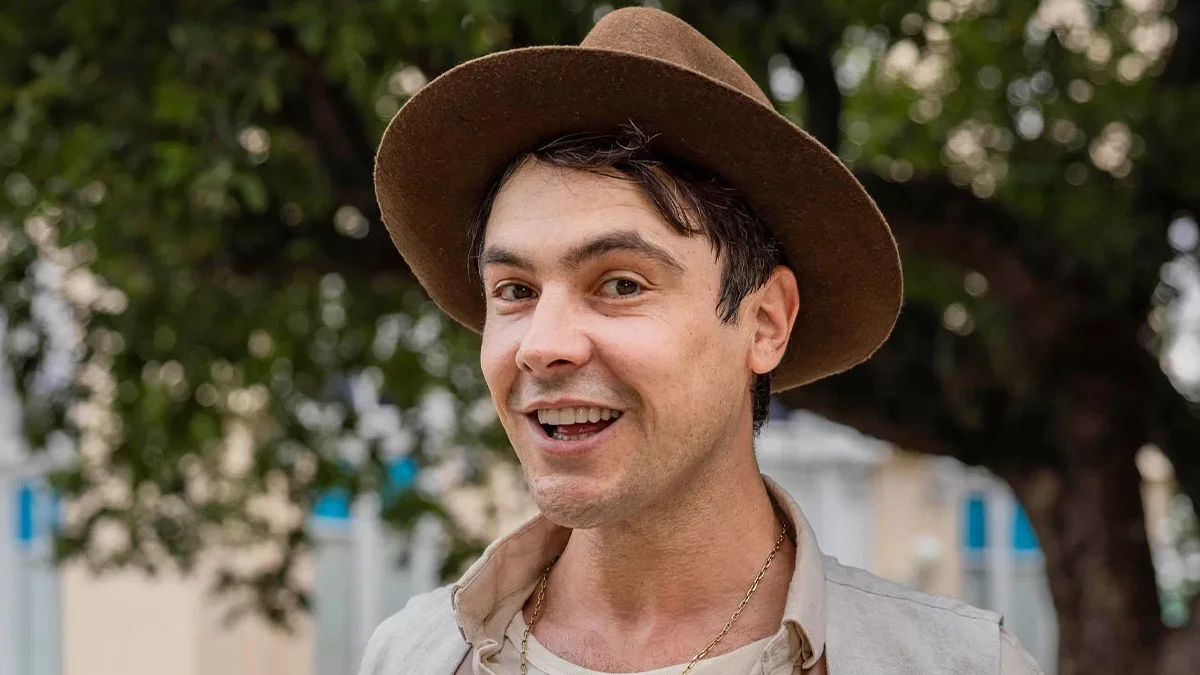 Pessoa sorrindo ao ar livre.