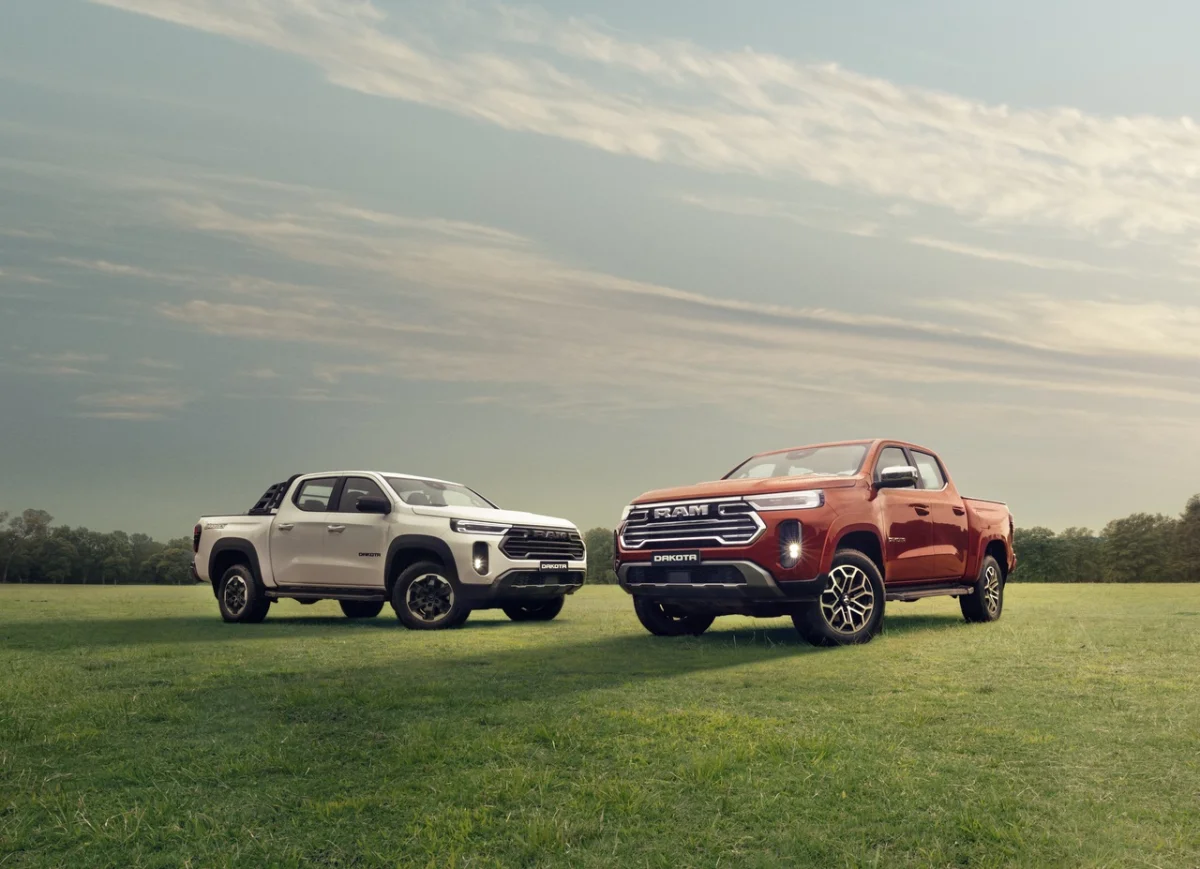 Vis&atilde;o lateral da Ram Dakota Laramie 2026 em um campo aberto.