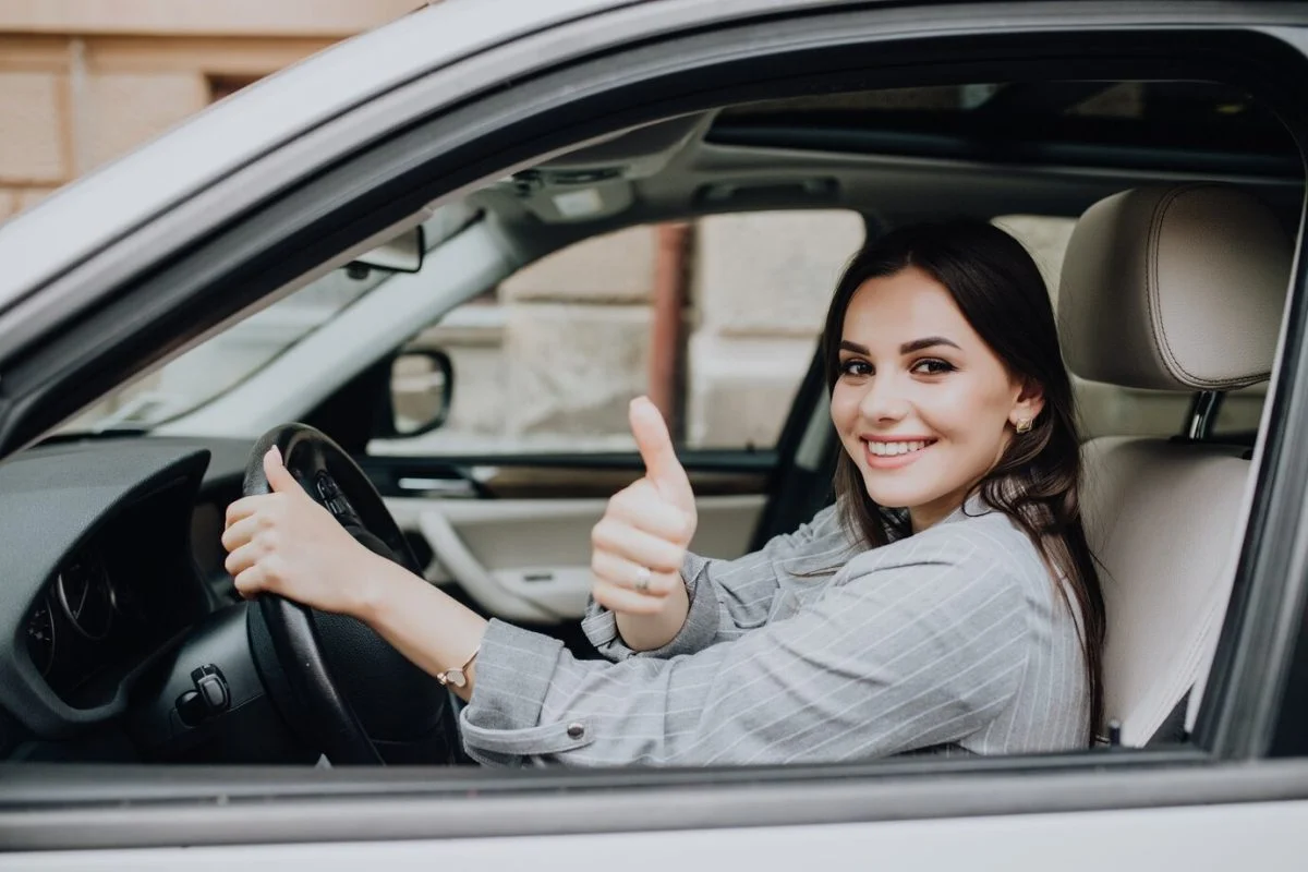 Pessoa dirigindo um carro com sinal de positivo
